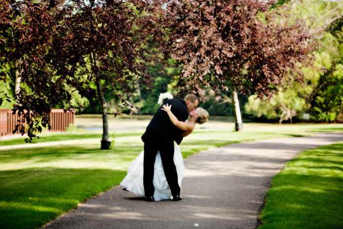 Bride and groom kissing at a park near Anoka, MN.