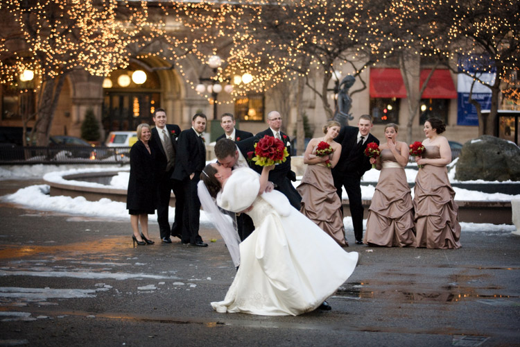 A winter wedding photo of Matt, Megan and their wedding party at Rice Park in downtown St. Paul, MN.