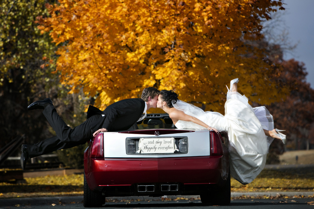 fall-colors-bride-groom-kissing-cadillac-convertable