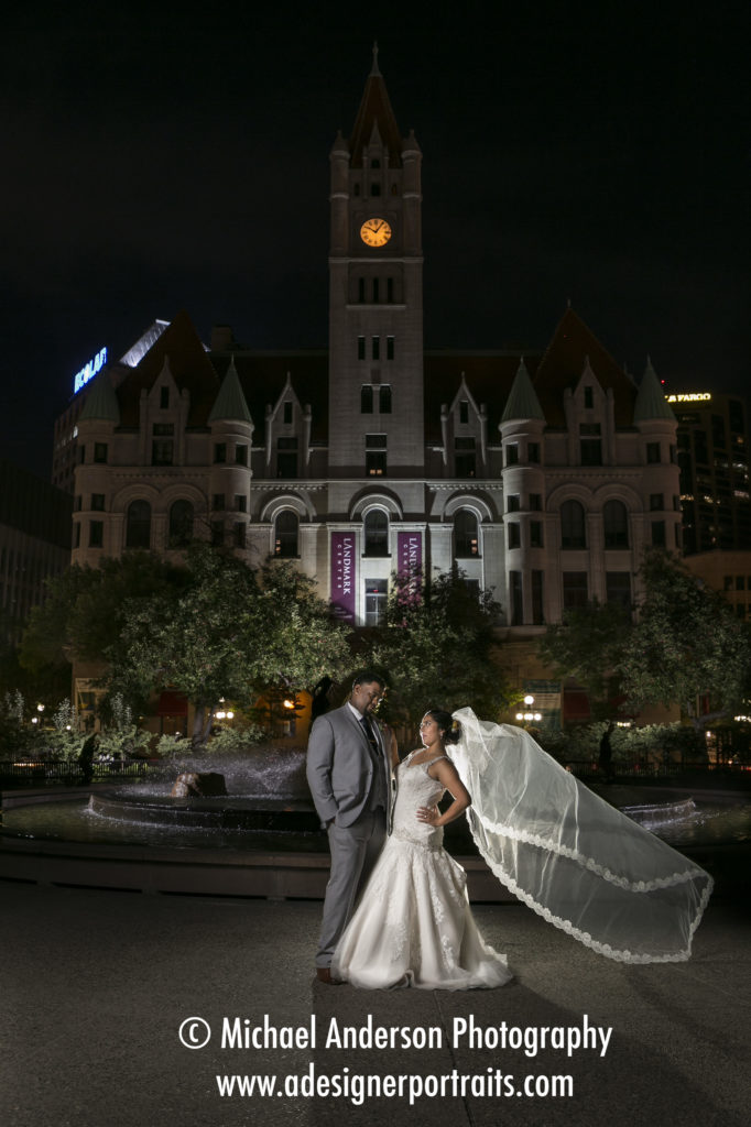 A fun nighttime wedding photo created by light painting with strobe lights. Photo of the bride and groom at Rice Park in downtown Saint Paul, MN. (after)