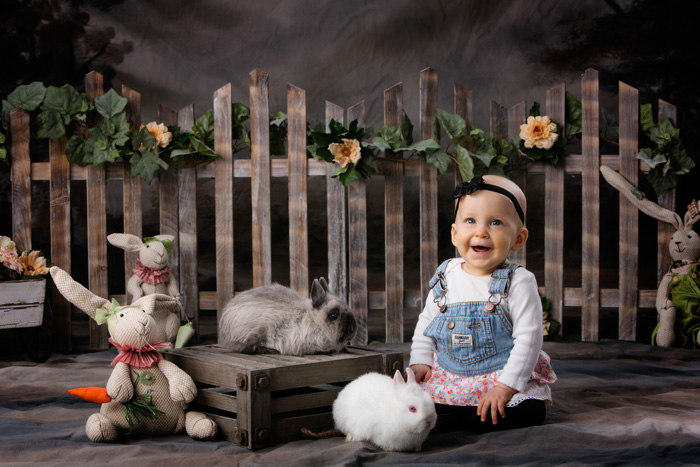 Easter Portraits with bunnies of a nine month old girl with bunnies.