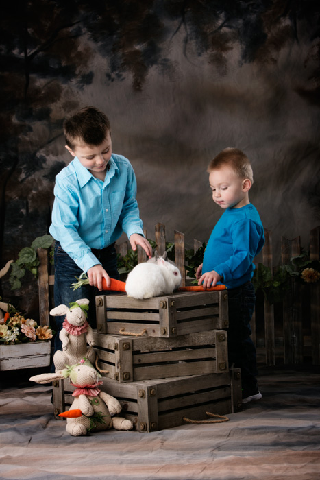 Anderson's Easter portrait specials of two brothers with live bunnies in the photography studio.