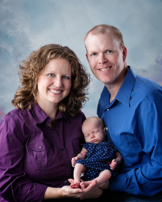 Newborn portrait photography of a one month old baby girl and her parents.