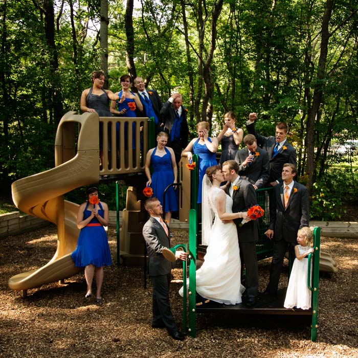 Bride, groom and their wedding party on the jungle gym at Kordiak Park in Columbia Heights, MN.