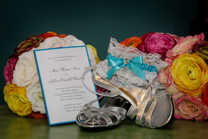 Wedding details including the wedding invitation, bride's shoes, flowers and wedding rings. Images taken at an Eagle Brook Church wedding.