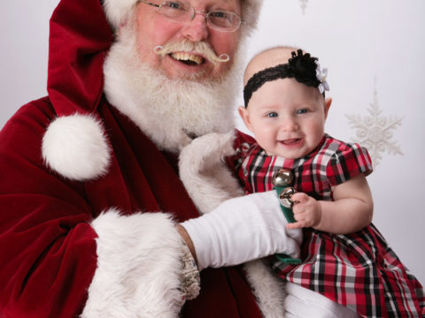 Five month old Claire stopped by Anderson's studio for her portraits with Santa Claus.