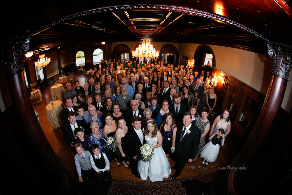 Semple Mansion Wedding Photos. Bride, groom and all of their wedding guests in front of the grand staircase at Semple Mansion in Minneapolis, MN