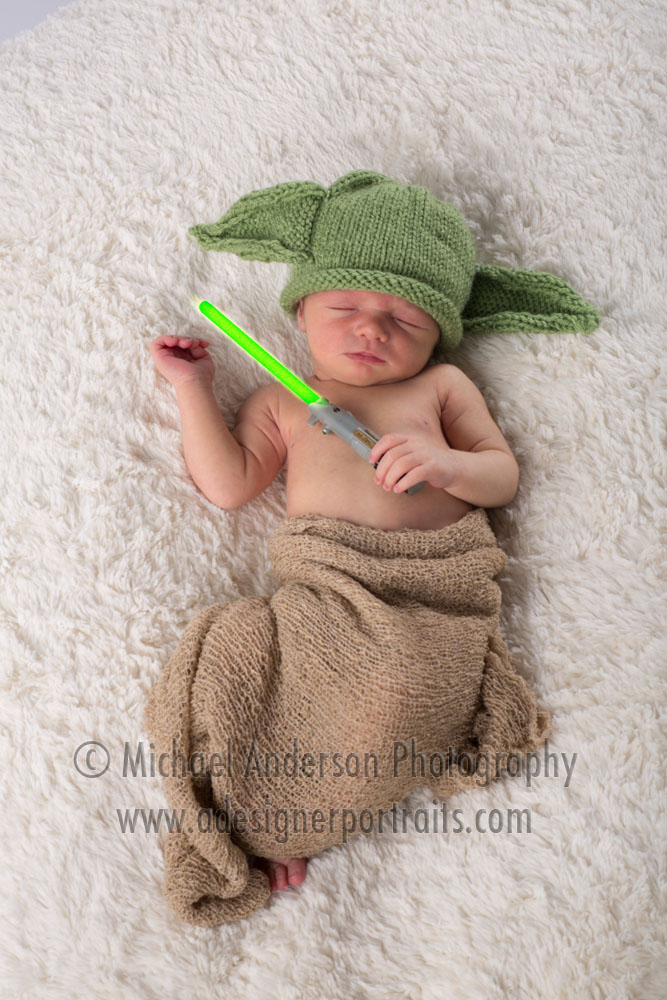 Newborn Baby Boy Portraits. Baby boy dressed as "Yoda" from Star Wars and sporting a light saber too!