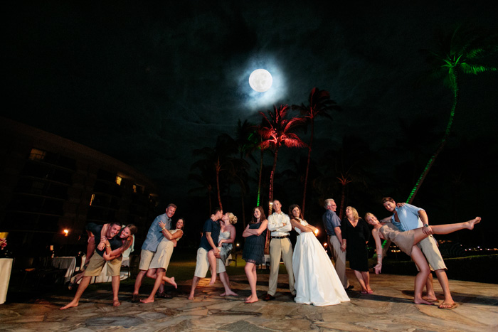 Anderson's wedding photography equipment. Bride, groom and their guests having fun “on the dance floor” under a Hawaiian full moon. Wedding photography equipment used to create this wedding photograph was a Canon 5D camera, a Canon 15mm fisheye lens & four Canon 550EX Speedlites from Anderson's wedding photography equipment.