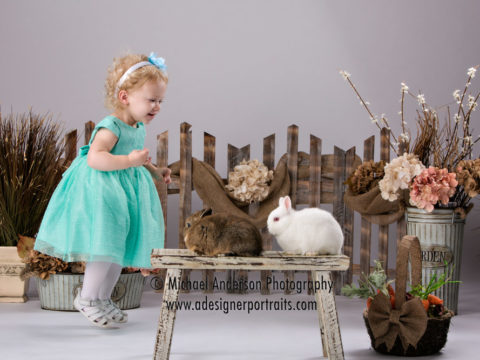 Charlotte hops with the bunnies in her 2015 real Easter Bunny photos.
