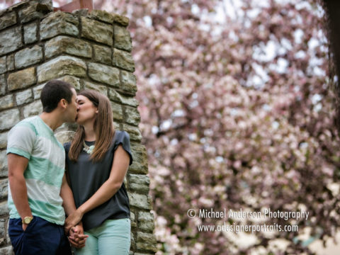 Michelle and Adam and one of their fun engagement photos taken in front of a flowering crabapple tree in Anoka, MN.