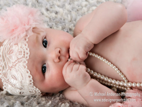 Adorable baby girl in one of her four month old portraits.