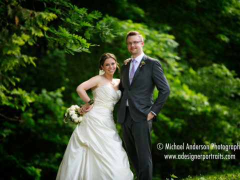 Bride and groom having a little fun in the beautiful forest just before their Minnesota Landscape Arboretum wedding.