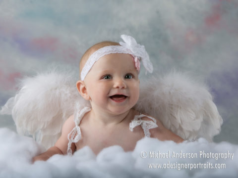 Six month baby photos of a little girl dressed as an angel.