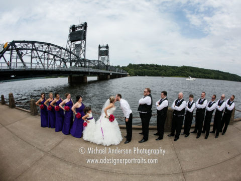 Stillwater wedding photography of a wedding party by the Saint Croix River with the famous lift bridge in the background.