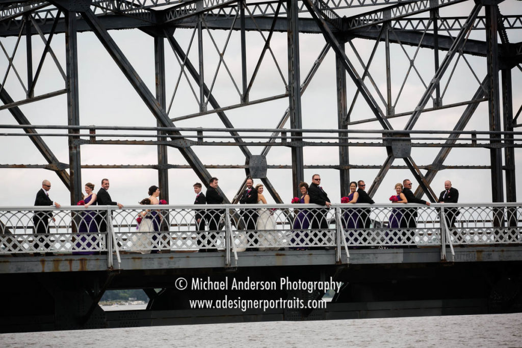 Stillwater wedding photography of a wedding party having fun on the famous lift bridge in Stillwater, MN.