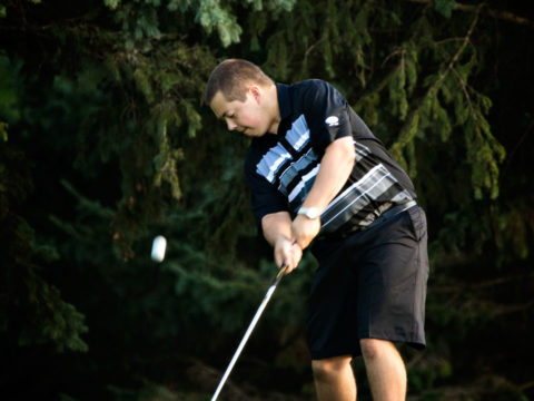 Brandon playing golf at Bristol Ridge Golf Course in Somerset, Wisconsin during his North High School senior portraits.