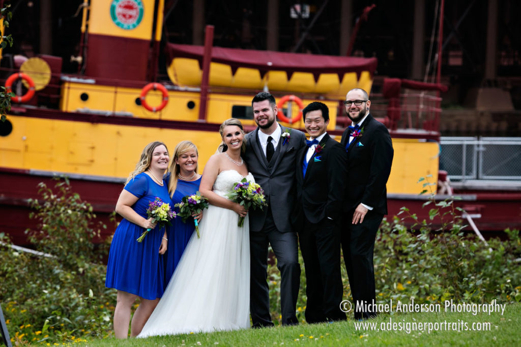 Destination wedding photography of a wedding party by the ore docks in Two Harbors, MN.