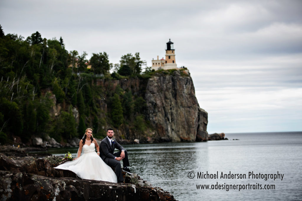 Split Rock Lighthouse wedding photography of the bride & groom on the rocky Lake Superior shoreline.