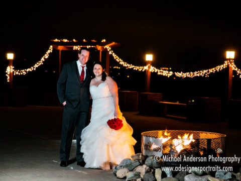 Night photo of the bride & groom by the fire pit The Wilds Golf Club in Prior Lake, MN.