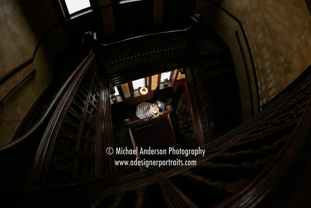 Bride & groom on the beautiful wooden staircase at the Historic Concord Exchange in South Saint Paul, MN.