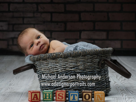 One of Ashton's newborn portraits taken in a cute basket with his name spelled out in toy blocks.