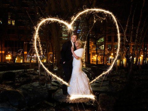 Pretty wedding photo of Michelle & Ben in the center of a heart shape made from sparklers at Mears Park in downtown Saint Paul, MN.