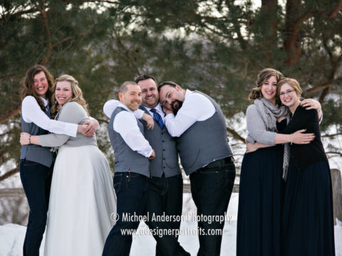 Winter wedding photograph of a wedding party taken in the snow at Crystal Lake Golf Club in Lakeville, MN.