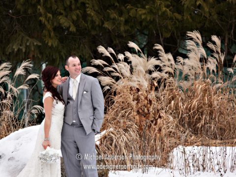 Winter destination wedding candid photo of a bride & groom in the woods just outside of the Gull Lake Center at the historic Grand View Lodge in Nisswa, Minnesota.