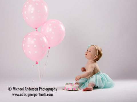 Kylie's one year portraits with a cute birthday cake and pink balloons!