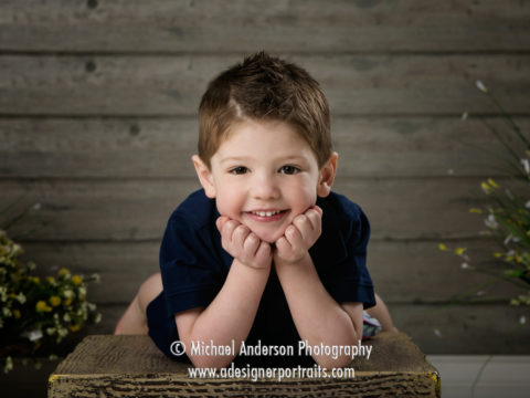 Having a little fun on a wooden box during Logan's four year old portraits.