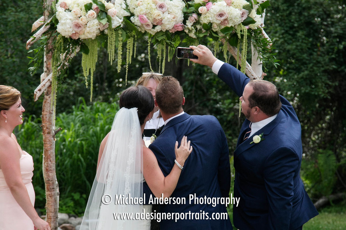 The best man takes of "selfie" of the bride and groom. The funny moment was just before they were introduced as husband and wife at the end of their Grand View Lodge wedding at The Vineyard there.