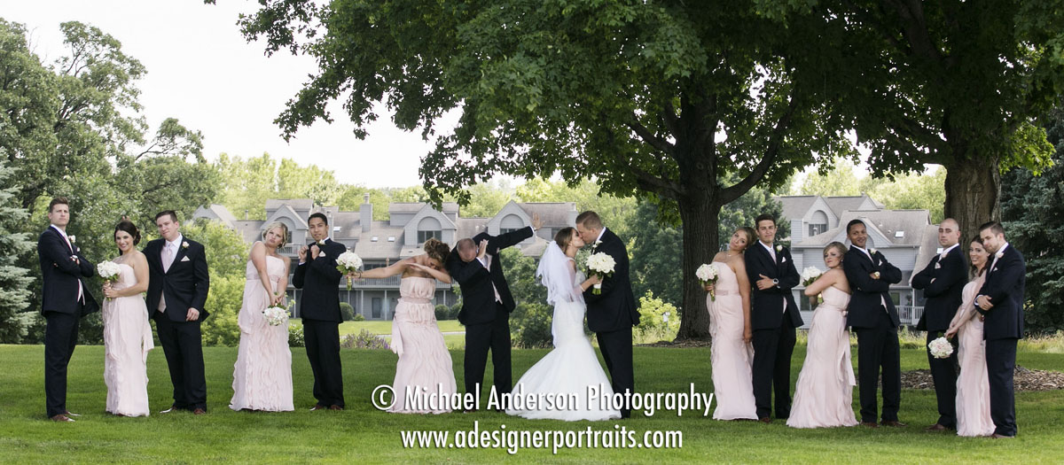 Wedding photo of a wedding party having a little fun at Brackett's Crossing Country Club in Lakeville, MN.