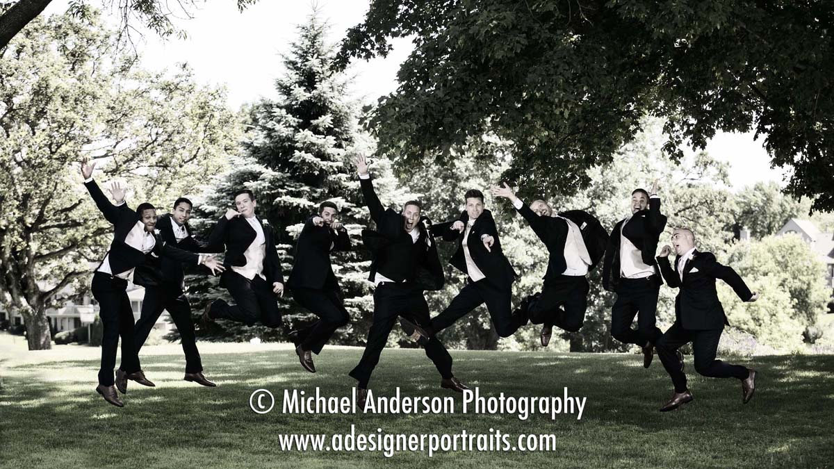 Groom and his groomsmen jumping high in the air. A fun wedding photograph taken at Brackett's Crossing Country Club in Lakeville, MN.