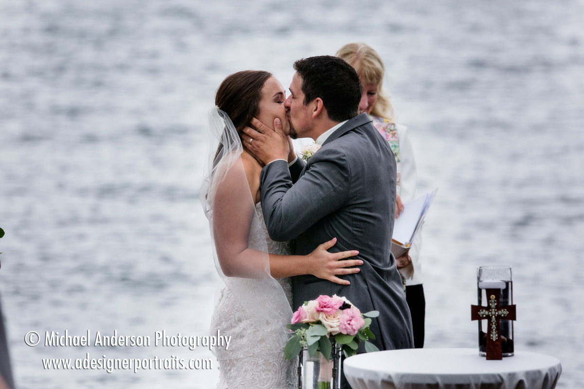 The bride & groom kiss just after being announced as husband & wife at the conclusion of their Superior Shores wedding on Lake Superior.