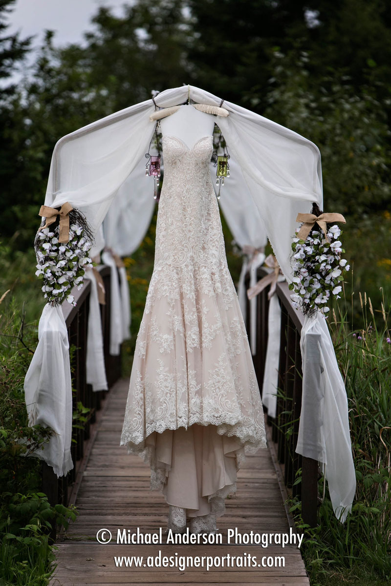 A very pretty wedding dress hanging on the decorated arches over the foot bridge at Superior Shores Resort & Conference Center in Two Harbors, MN.