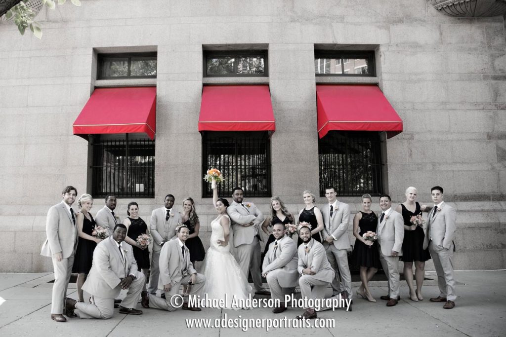 A colorized B&W wedding photo of the wedding party at the Landmark Center in Saint Paul, MN.