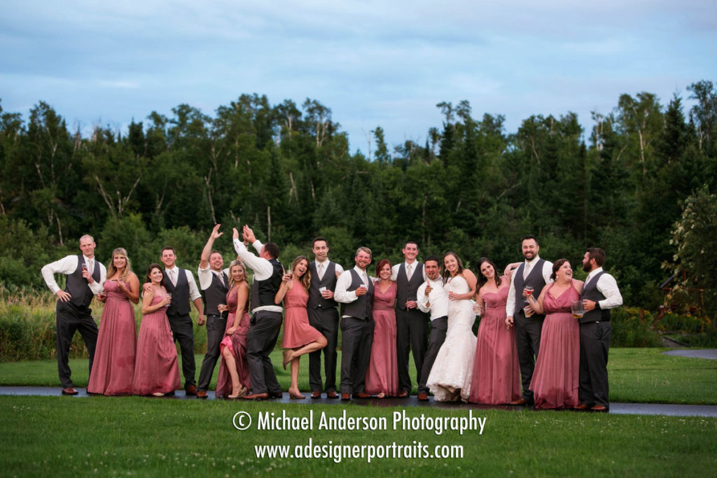 A wild and crazy wedding party having a little fun outdoors once the rain finally subsided at their Superior Shores wedding.