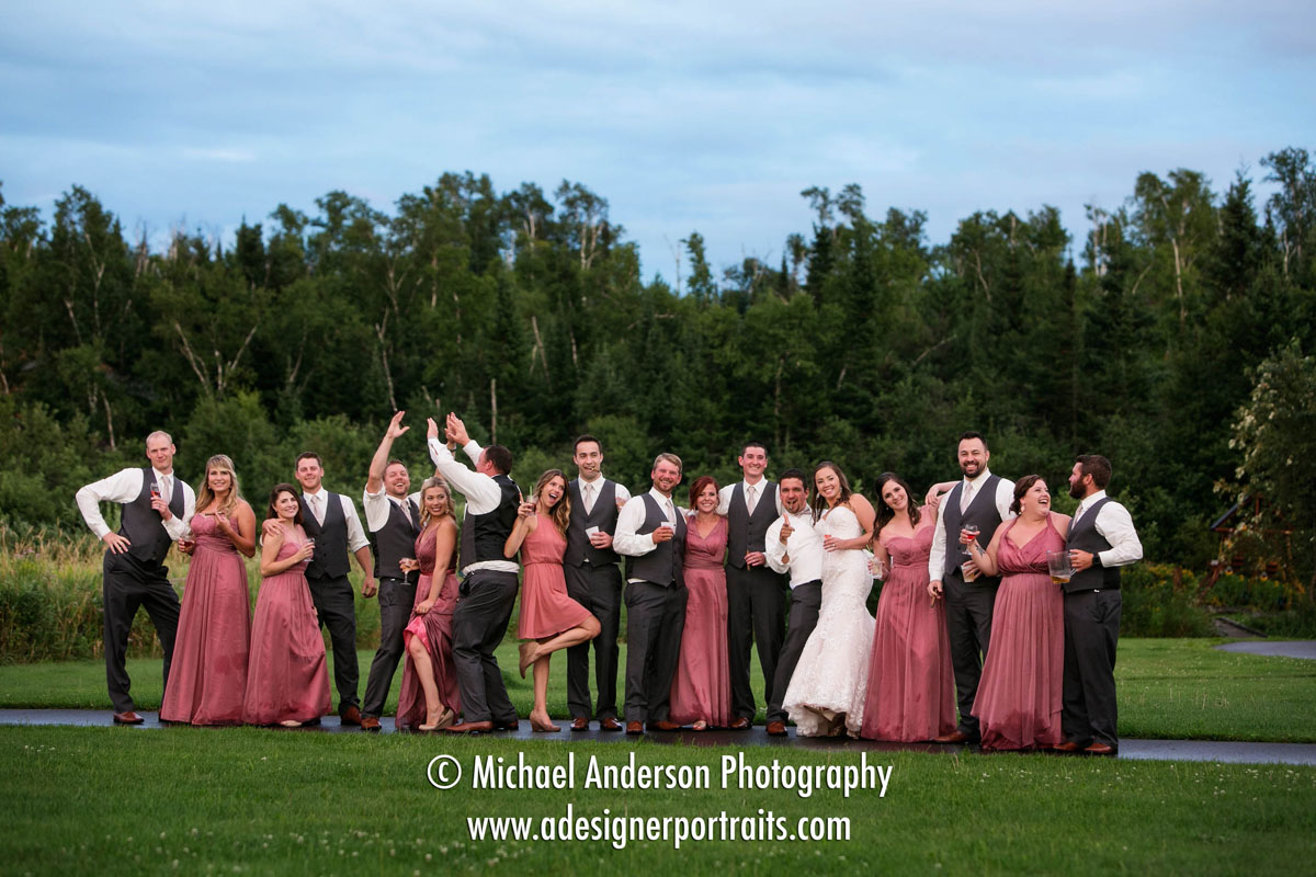 A wild and crazy wedding party having a little fun outdoors once the rain finally subsided at their Superior Shores wedding.