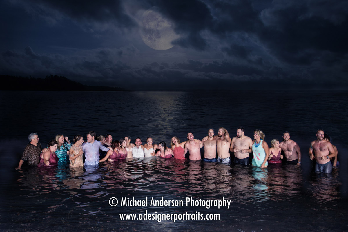 A wedding party takes a swim in Lake Superior under a near full moon. Photo taken at the conclusion of their Superior Shores wedding dance.