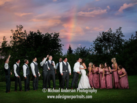 A crazy wedding party having a pretty good time outdoors just after a rain storm passed. The resulting rainbow made for a pretty "bonus" wedding photo at their Superior Shores wedding reception.