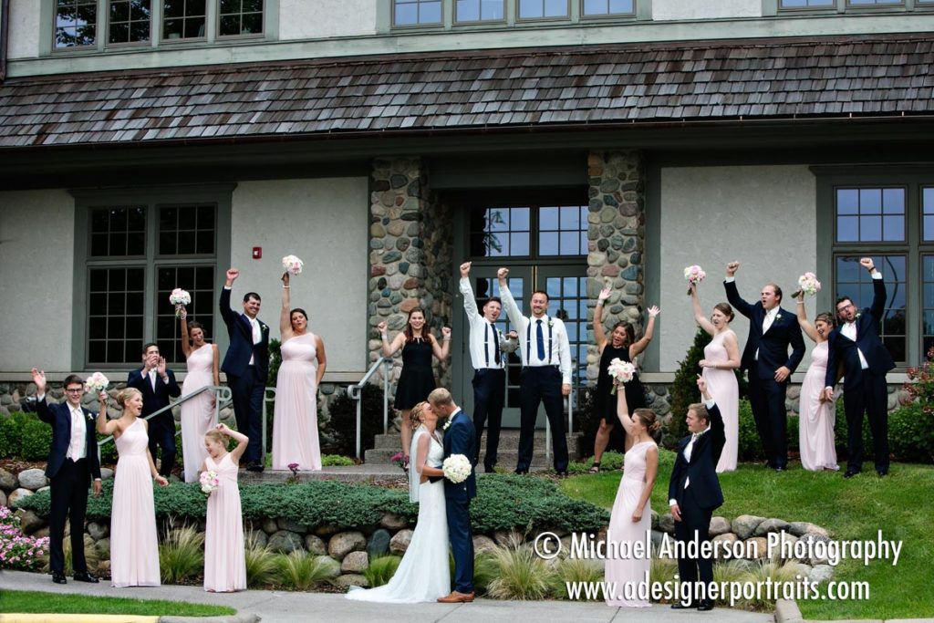 A full wedding party posing on the front steps moments before their Rush Creek wedding in Maple Grove, MN.