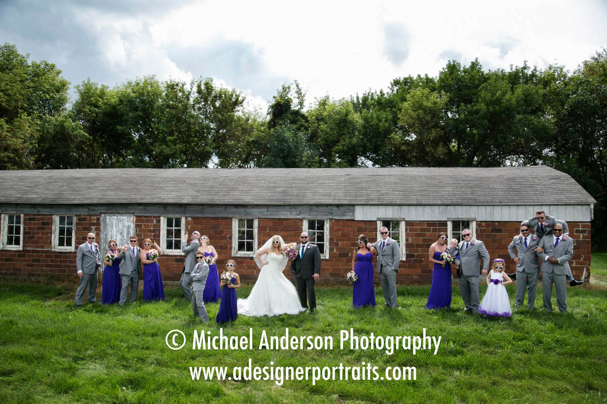 A wild and crazy wedding party pose at an old abandoned barn in Prior Lake, MN.