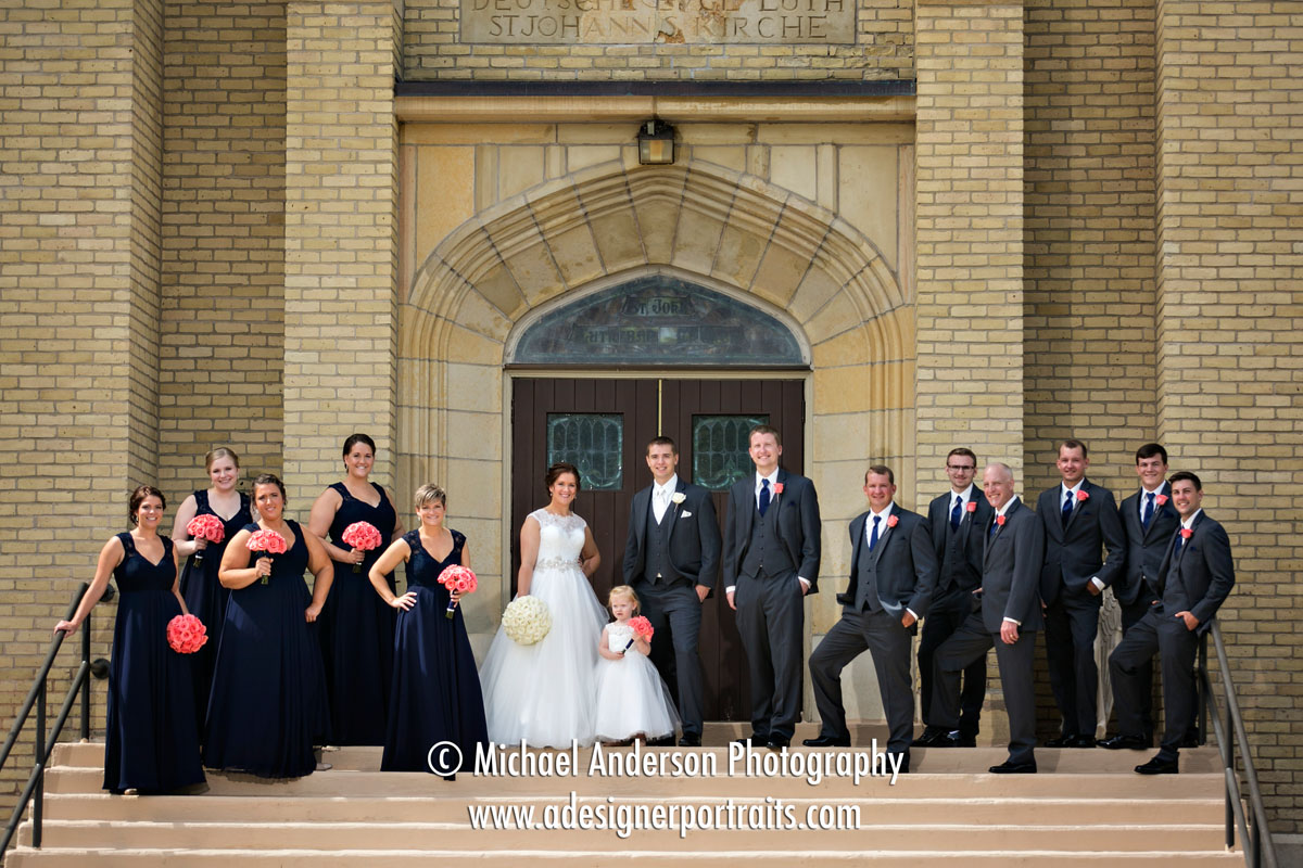 A fun wedding party photo taken on the front steps of Saint John Lutheran Church in Belle Plaine, MN. Image was created just before their Saint John Lutheran Church wedding ceremony.