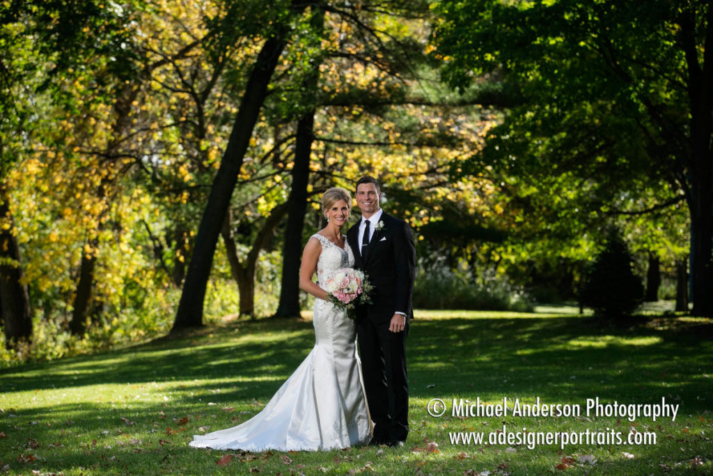 Beautiful backlit fall wedding photo of the bride & groom taken at Mississippi Gardens in Minneapolis, MN.