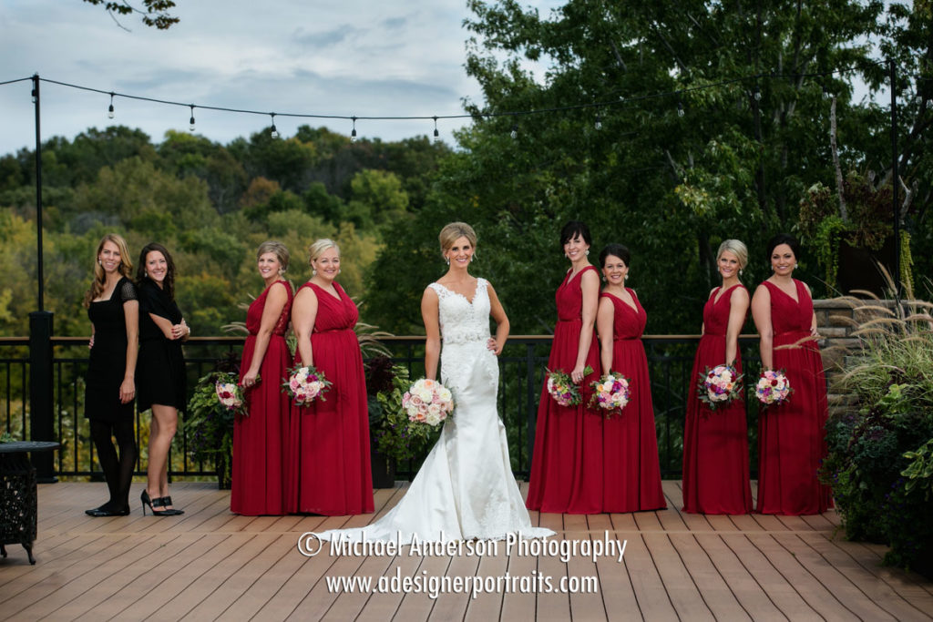 Wedding photo of the bride, her bridesmaids and personal attendants on the deck before her Mississippi Gardens wedding day in Minneapolis, MN.