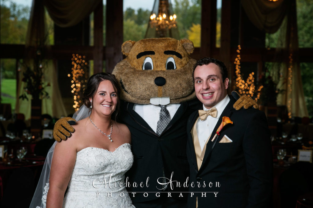 The bride and groom along with surprise wedding guest Goldy Gopher pose together at their Vadnais Heights Commons wedding reception.