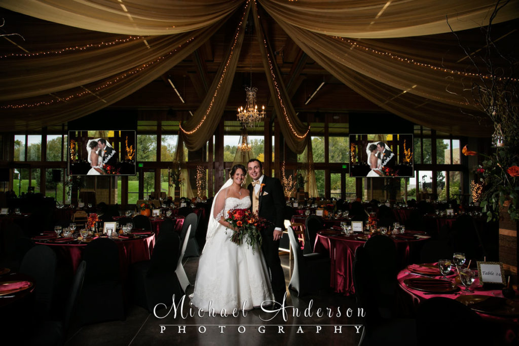 Wide angle photo of the bride & groom in the center of the beautiful ballroom. Wedding photo taken just before their Vadnais Heights Commons wedding reception in Vadnais Heights, MN.