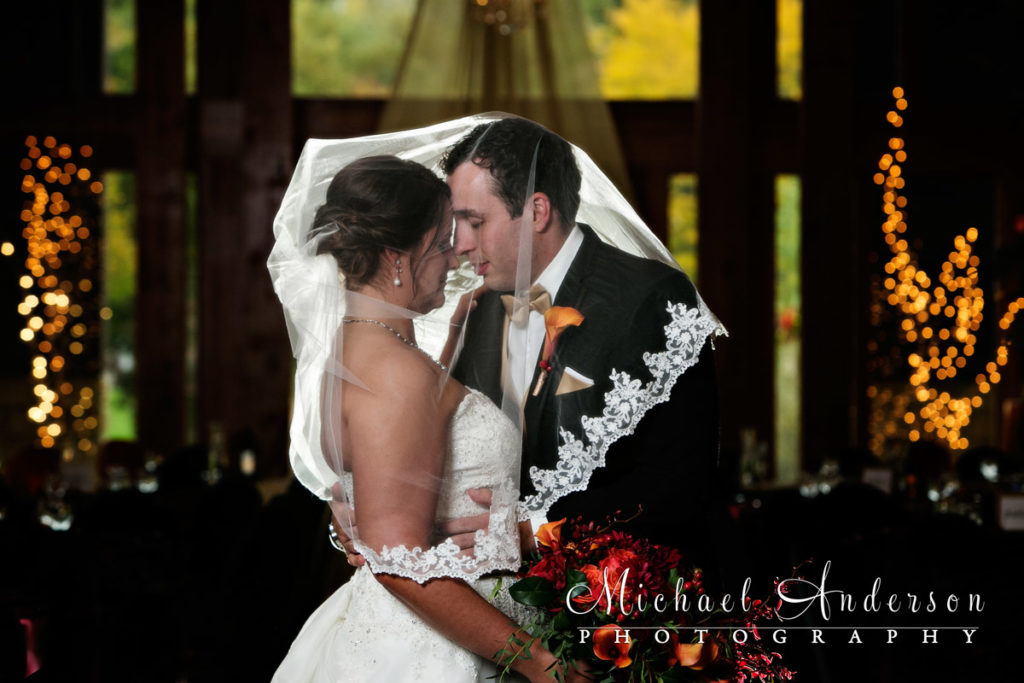 Cute bridal portrait of the bride & groom under her veil. Wedding photo taken at their Vadnais Heights Commons wedding reception.