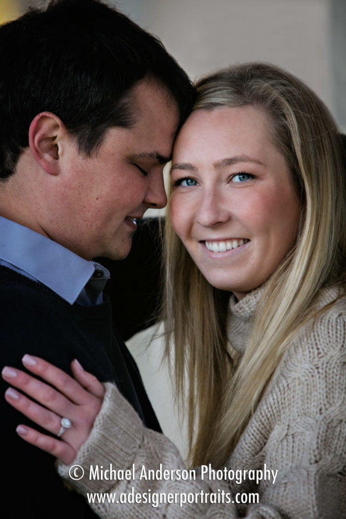 Close up of a cute couple during their engagement portrait session on St. Anthony Main in Minneapolis, MN.